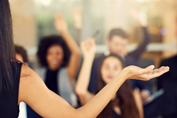 Cropped shot of businesspeople hands raised asking questions during a seminar